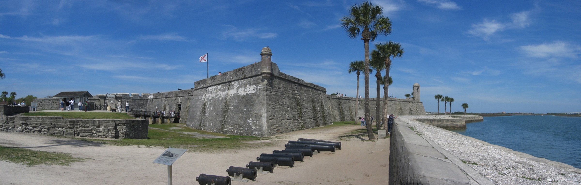 Wide daylight panorama of Castillo de San Marcos, its cannons, palms, and Matanzas Bay